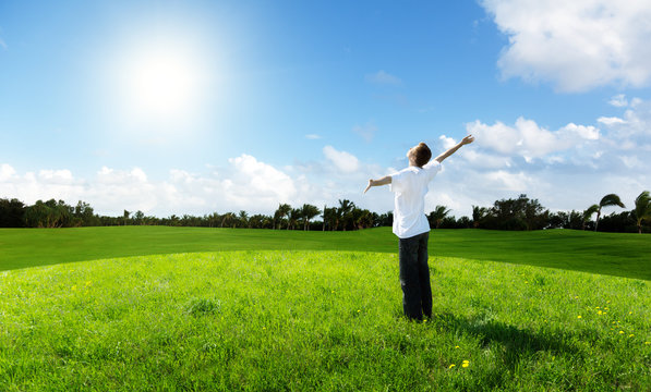 young man relax on the green field