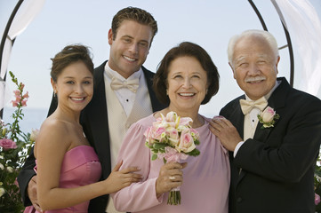 bride and groom with parents outdoors (portrait)