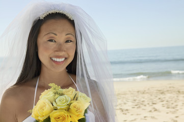 bride with bouquet on beach (close-up) (portrait)