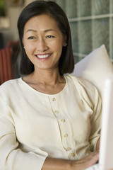 woman sitting on sofa with laptop