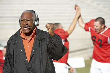 football coach shouting and pumping fist on sideline