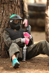 Young woman playing paintball