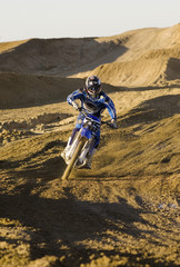 Obraz premium motocross racer riding on dirt track