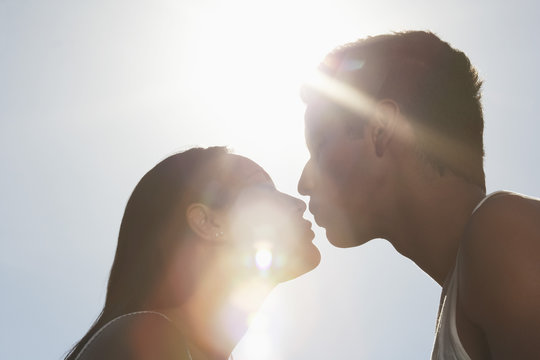 Couple Kissing Outdoors In Sunlight Profile