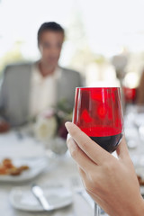 young woman holding wineglass close-up