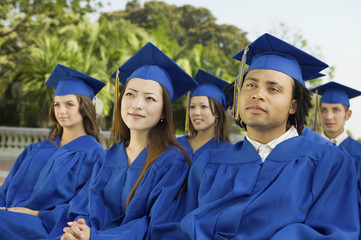 graduates listening to ceremony outside