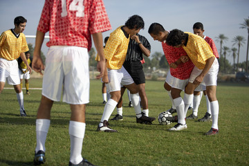 soccer players competing for ball