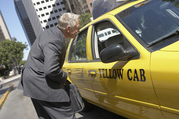 businessman talking to taxi driver