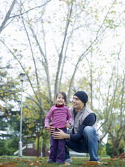 Naklejka premium girl (3-4) standing with father squatting in park