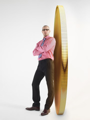 man in glasses leaning against giant coin digital composite