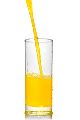 orange juice poring into glass isolated on white