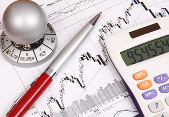 Financial chart, white calculator and a red pen