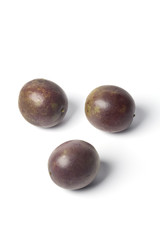 Three whole maracujá on white background