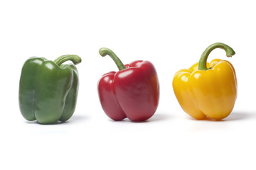Green,red and yellow bell pepper on white background