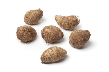Whole taro yams on white background