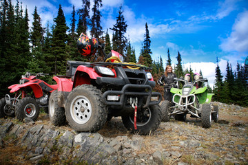 Group of quadbikes parked on top of a mountain