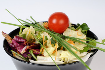 bowl with salad and red tomato