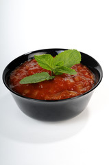 closeup of black bowl with red sauce