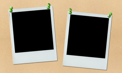 two polaroid photos hung on bulletin board