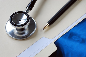 A stethoscope on the top of a medical folder