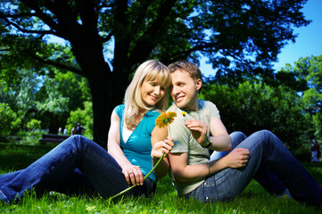 Happy man and woman with flowers