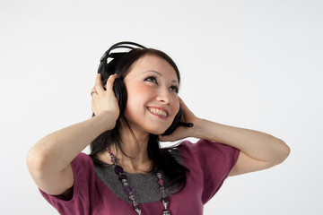 attractive smiling woman with headphones on white background