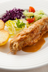 Roasted stuffed pork chop with chips and vegetables