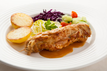 Roasted stuffed pork chop with chips and vegetables