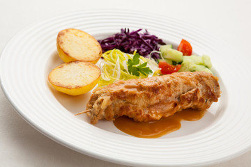 Roasted stuffed pork chop with chips and vegetables