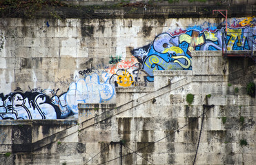 Graffiti on banks of river tiber in rome italy