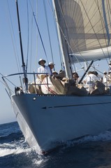 crew on sailboat on ocean