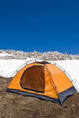 orange touristic tent on a snow