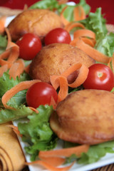 Doughnuts on a bed of lettuce, carrots and tomatoes