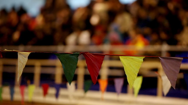 Flag barrier with crowd on background