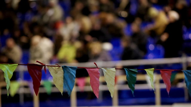 Flag barrier with crowd on background