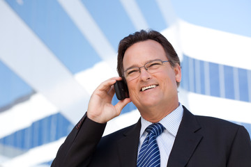 Businessman Smiles as He Talks on His Cell Phone