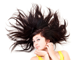 beautiful young woman lying on white with scatter hair