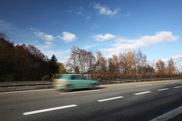 Speeding concept - Cars moving fast on a highway on a lovely a