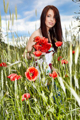 Pretty woman in poppy flowers