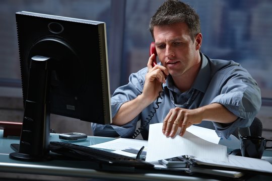 Businessman on call in overtime