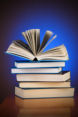 Stack of books against gradient background