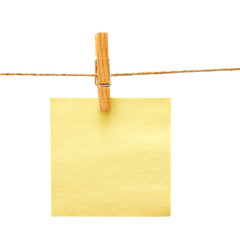 Yellow reminder with clothes peg over white