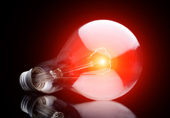Photo of light bulb on black.