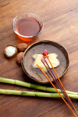 flower in ancient wood bowl with oil massage spa concept