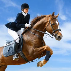 Rolgordijnen Equestrian jumper - Young girl jumping with sorrel horse © Kseniya Abramova