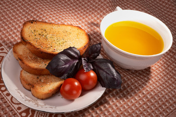 Toasts, olive oil, basil grass and tomatos
