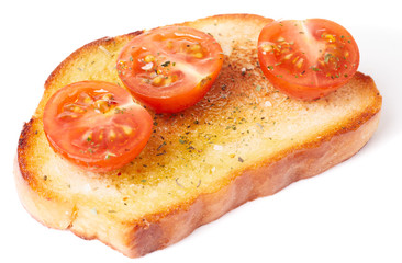 Piece of bread with olive oil and tomatoes