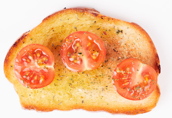 Piece of bread with olive oil and tomatoes