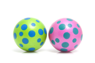 Two colorful dotted balls over white background
