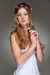 beautiful young woman with small flower